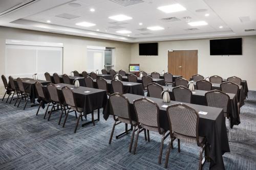 a conference room with tables and chairs and a podium at Holiday Inn Express & Suites Chicago North Shore - Niles by IHG in Niles