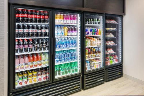 a refrigerator filled with lots of different types of drinks at Holiday Inn Express & Suites Chicago North Shore - Niles by IHG in Niles