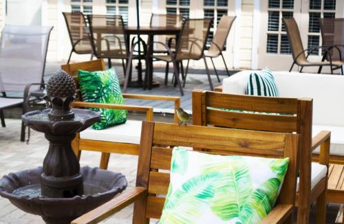 a bird sitting on top of two chairs on a patio at Duval House in Key West