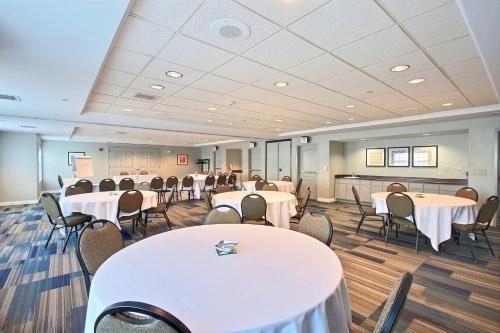 a conference room with tables and chairs in it at Holiday Inn Express Hotel & Suites Milwaukee Airport by IHG in Milwaukee