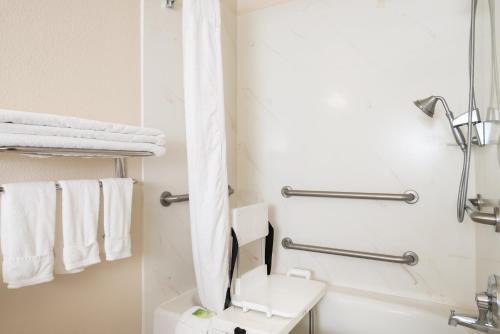 a bathroom with a toilet and a sink and towels at Holiday Inn Express & Suites Yosemite Park Area by IHG in Chowchilla