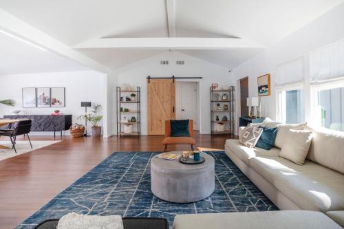 a living room with a couch and a table at Enchanting Sherman Oaks Home With Pool permit #HSR two one zero zero 2605 in Sherman Oaks