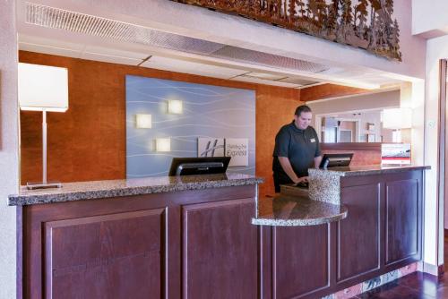 a man standing at a bar in a hotel room at Holiday Inn Express Hotel & Suites Raton, an IHG Hotel in Raton