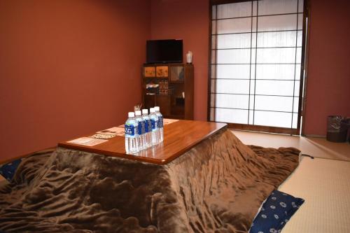 a table with bottles of water on it in a room at Nishioji KADO 西大路 角 わんちゃんと泊まれるお宿 in Kyoto