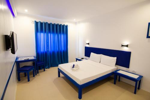 Postel nebo postele na pokoji v ubytování Skytel Palawan