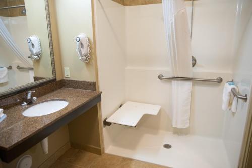a bathroom with a sink and a shower at Holiday Inn Express & Suites Northwood by IHG in Northwood