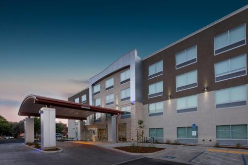 a hospital building with a large building at Holiday Inn Express & Suites Chico by IHG in Chico