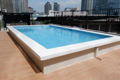 a swimming pool on the roof of a building at The Charter House in Manila
