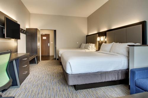 a hotel room with two beds and a flat screen tv at Holiday Inn Express & Suites - Summerville by IHG in Summerville