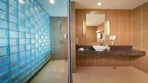 a bathroom with a sink and a shower at Holiday Inn Express Nantong Downtown, an IHG Hotel in Nantong