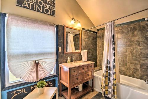 a bathroom with a sink and a tub and a shower at Eclectic Escape with Sunroom - 2 Miles to Downtown! in Dearborn