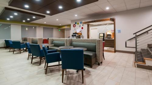 a waiting room with blue chairs and tables at Holiday Inn Express Hotel & Suites Everett by IHG in Everett