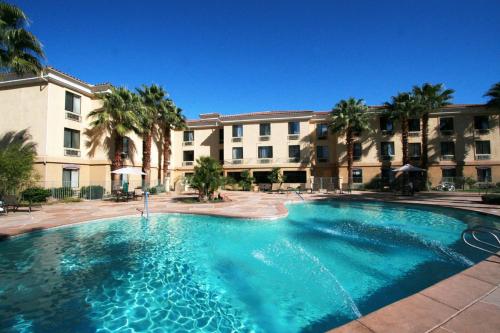a large swimming pool in front of a building at Hampton Inn & Suites Cathedral City in Cathedral City