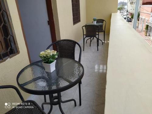 a glass table with a vase of flowers on it at Hotel Las Vegas by CMS hotels in Santa Marta