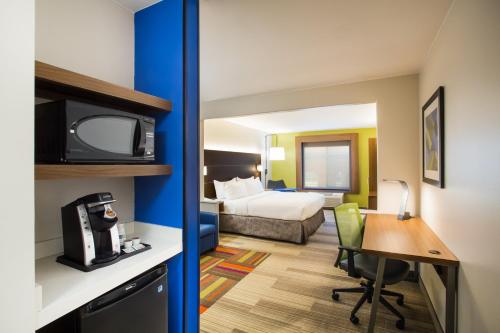 a hotel room with a bed and a desk at Holiday Inn Express Hotel & Suites Cedar City by IHG in Cedar City