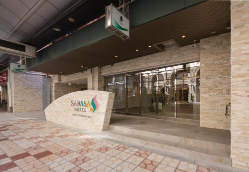 a building with a synergy market sign in front of it at SARASA HOTEL Namba in Osaka
