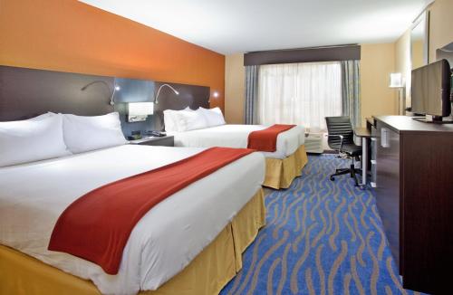 a hotel room with two beds and a television at Holiday Inn Express & Suites St Louis Airport by IHG in Woodson Terrace