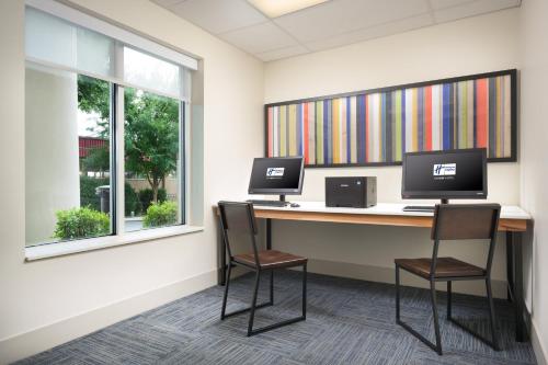 a office with two computers on a desk with two chairs at Holiday Inn Express Hotel & Suites Chattanooga Downtown, an IHG Hotel in Chattanooga