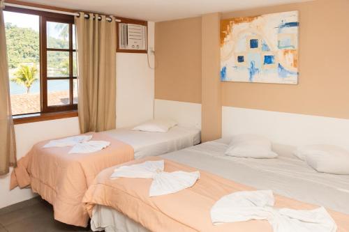 Tempat tidur dalam kamar di Itacuruçá Inn