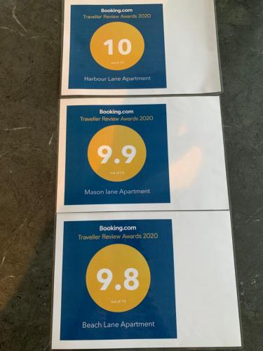 a row of signs with the number and on them at Beach Lane Apartment in Whangarei