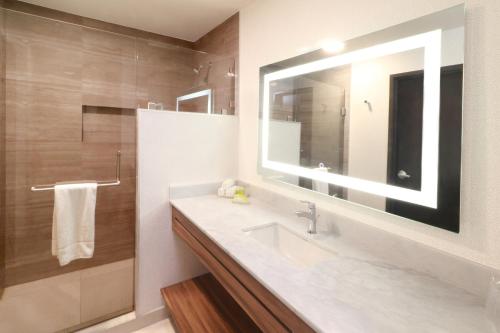 a bathroom with a sink and a mirror at Holiday Inn & Suites Monterrey Apodaca Zona Airport, an IHG hotel in Monterrey