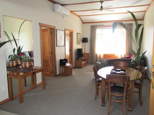 a living room with a table and a couch at Tarawhata Thermal Apartment in New Plymouth