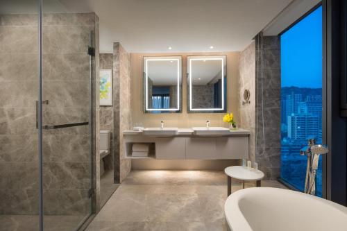 a bathroom with two sinks and a shower at Holiday Inn & Suites Lanzhou Center, an IHG Hotel in Lanzhou