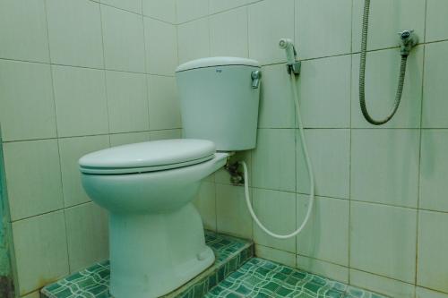 a bathroom with a toilet and a shower at Hotel Taman Indah in Madiun