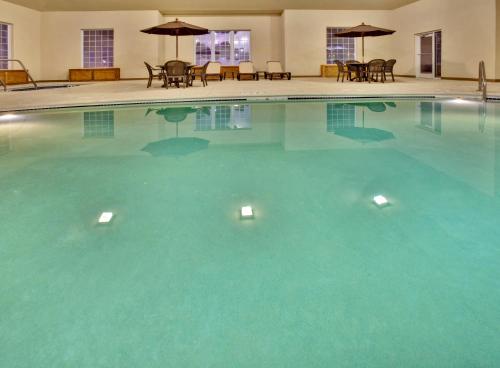 a large pool with blue water in a hotel at Holiday Inn Express Hotel & Suites Council Bluffs - Convention Center Area by IHG in Council Bluffs