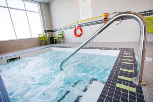 a swimming pool with a hose in a room at Holiday Inn Hotel & Suites Calgary South - Conference Ctr by IHG in Calgary