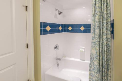 a bathroom with a tub and a sink and a shower at Holiday Inn Club Vacations South Beach Resort in Myrtle Beach