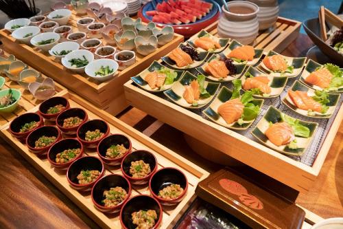 a buffet filled with different types of food in bowls at Hotel Nikko Bangkok in Bangkok