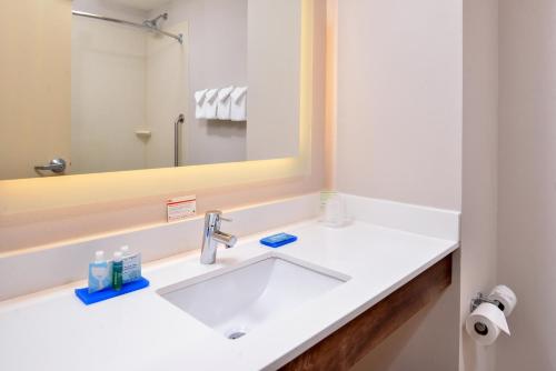 a bathroom with a sink and a mirror at Holiday Inn Express Hotel & Suites Cincinnati - Mason by IHG in Mason