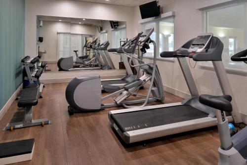 a gym with several treadmills and elliptical machines at Holiday Inn Express Hotel & Suites Cincinnati - Mason by IHG in Mason