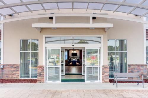 an open door of a house with a bench at Holiday Inn Lafayette North by IHG in Lafayette