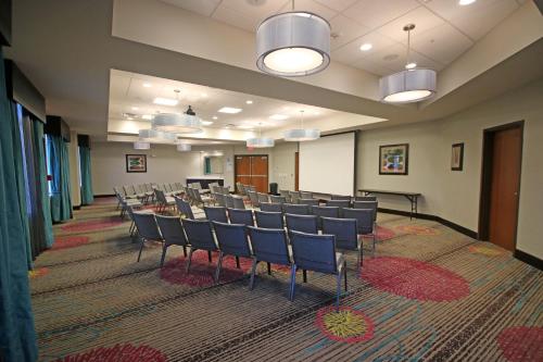 a conference room with chairs and tables in it at Holiday Inn Express & Suites Charlotte North by IHG in Charlotte