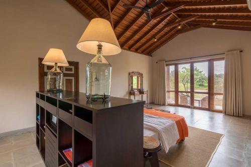 a bedroom with a bed with a fish in a glass jar at Kumbukgaha Villa in Sigiriya