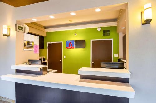 a bathroom with a green wall with sinks and toilets at Studio 6-Concord, CA in Concord