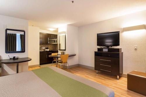 a hotel room with a bed and a flat screen tv at Studio 6-Concord, CA in Concord