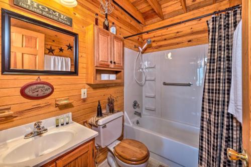 a bathroom with a sink and a shower and a toilet at Quiet and Private Cabin about 5 Mi to Dale Hollow Lake! in Burkesville