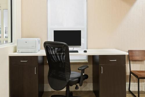 an office with a desk with a computer and a chair at Holiday Inn Express & Suites - Columbus Airport East by IHG in Columbus