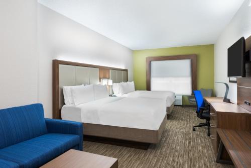 a hotel room with two beds and a tv at Holiday Inn Express & Suites - Columbus Airport East by IHG in Columbus