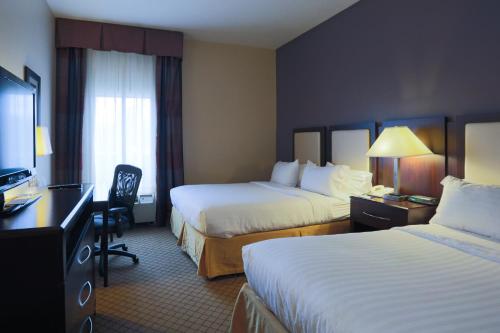a hotel room with two beds and a television at Holiday Inn Express Hotel & Suites Blythewood by IHG in Blythewood