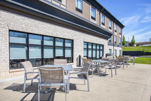 a row of tables and chairs in front of a building at Holiday Inn Express Hotel & Suites Glasgow by IHG in Glasgow