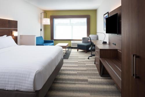 a hotel room with a bed and a television at Holiday Inn Express & Suites Ruston by IHG in Ruston