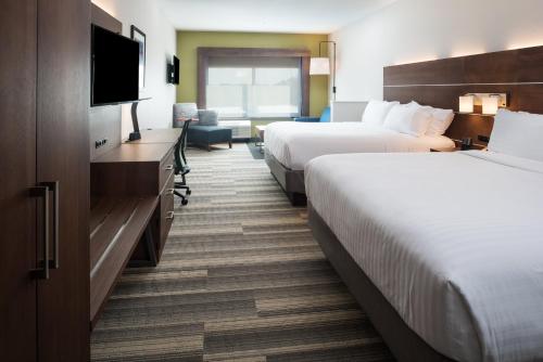 a hotel room with two beds and a flat screen tv at Holiday Inn Express & Suites Ruston by IHG in Ruston