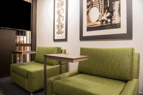 a living room with two chairs and a table at Holiday Inn Express & Suites Ruston by IHG in Ruston