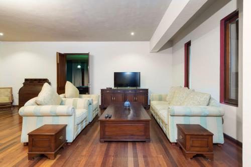 a living room with two couches and a coffee table at The Walden Nuwara Eliya in Nuwara Eliya