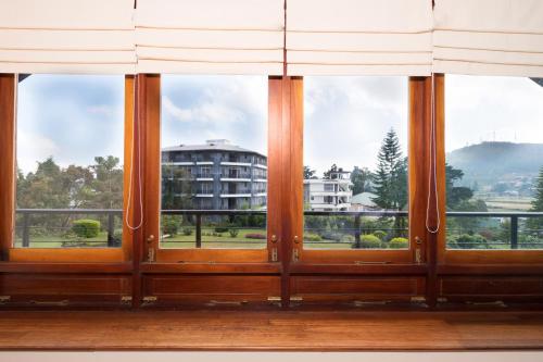 a group of windows with a view of a building at The Walden Nuwara Eliya in Nuwara Eliya