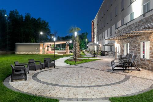 a group of chairs sitting outside of a building at Holiday Inn Express & Suites - Charlotte Airport by IHG in Charlotte